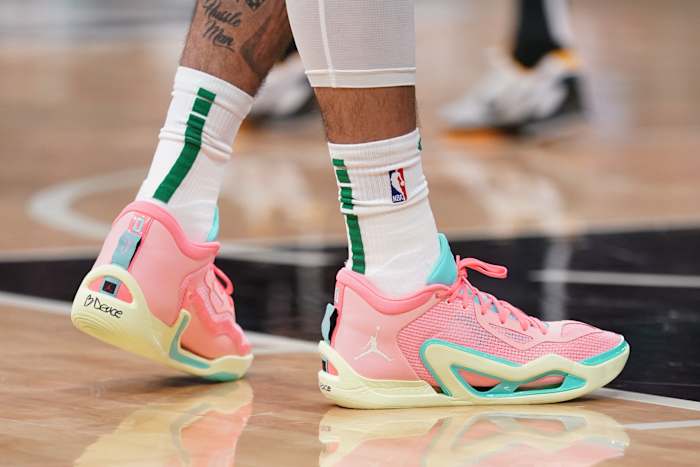 View of Jayson Tatum's pink and green Jordan Brand shoes.
